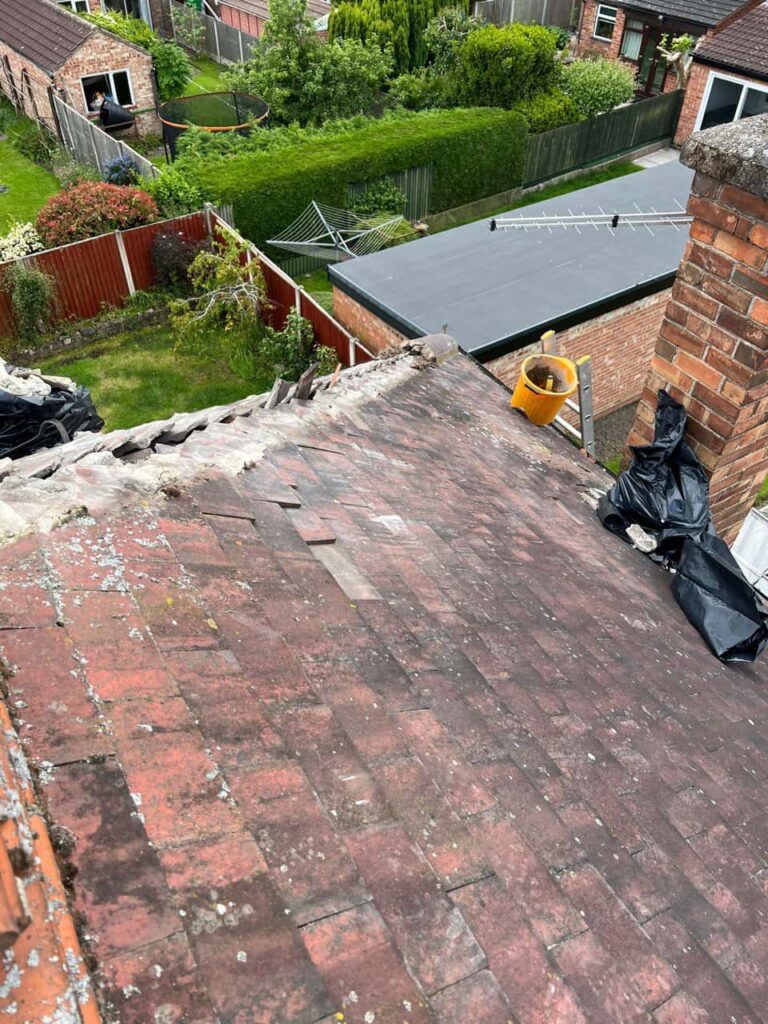 This is a photo of a roof where the hip tiles have been removed, and are just about to be replaced. Works carried out by Cotgrave Roofing Repairs