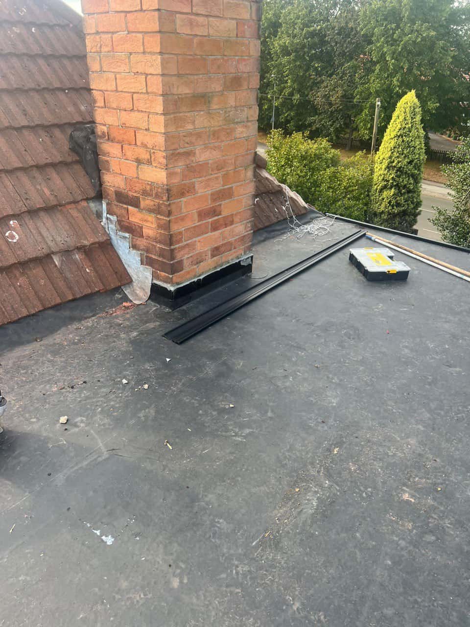 This is a photo of a flat roof which has just been repaired, there is also a chimney stack and some leadwork has also been dressed. Works carried out by Cotgrave Roofing Repairs